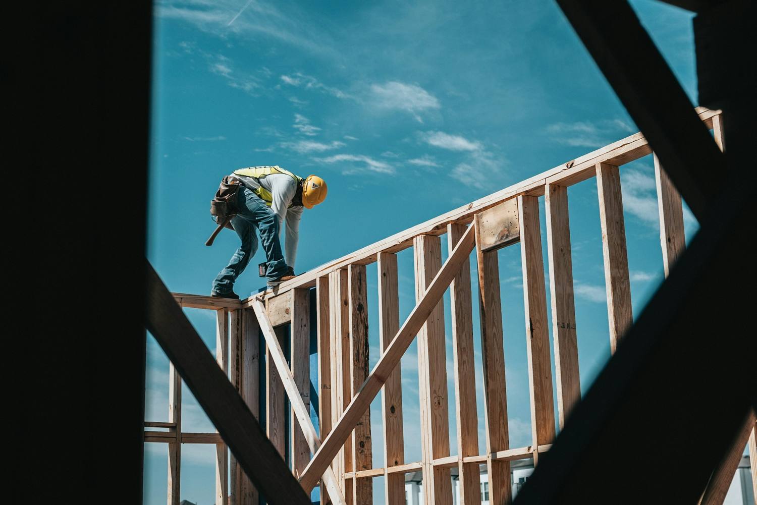 Framing crew working on an open wall frame