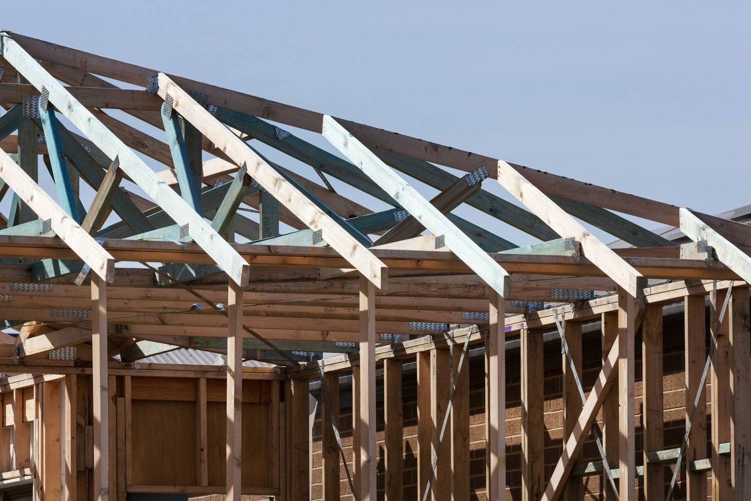 Roof trusses set on the exterior wall framing of a house